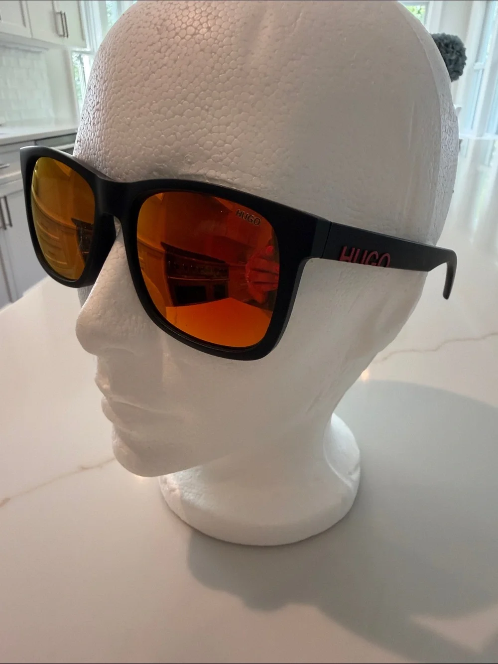 HUGO Men’s Black Sunglasses (recycled nylon) with Red-Orange Mirrored Lenses.